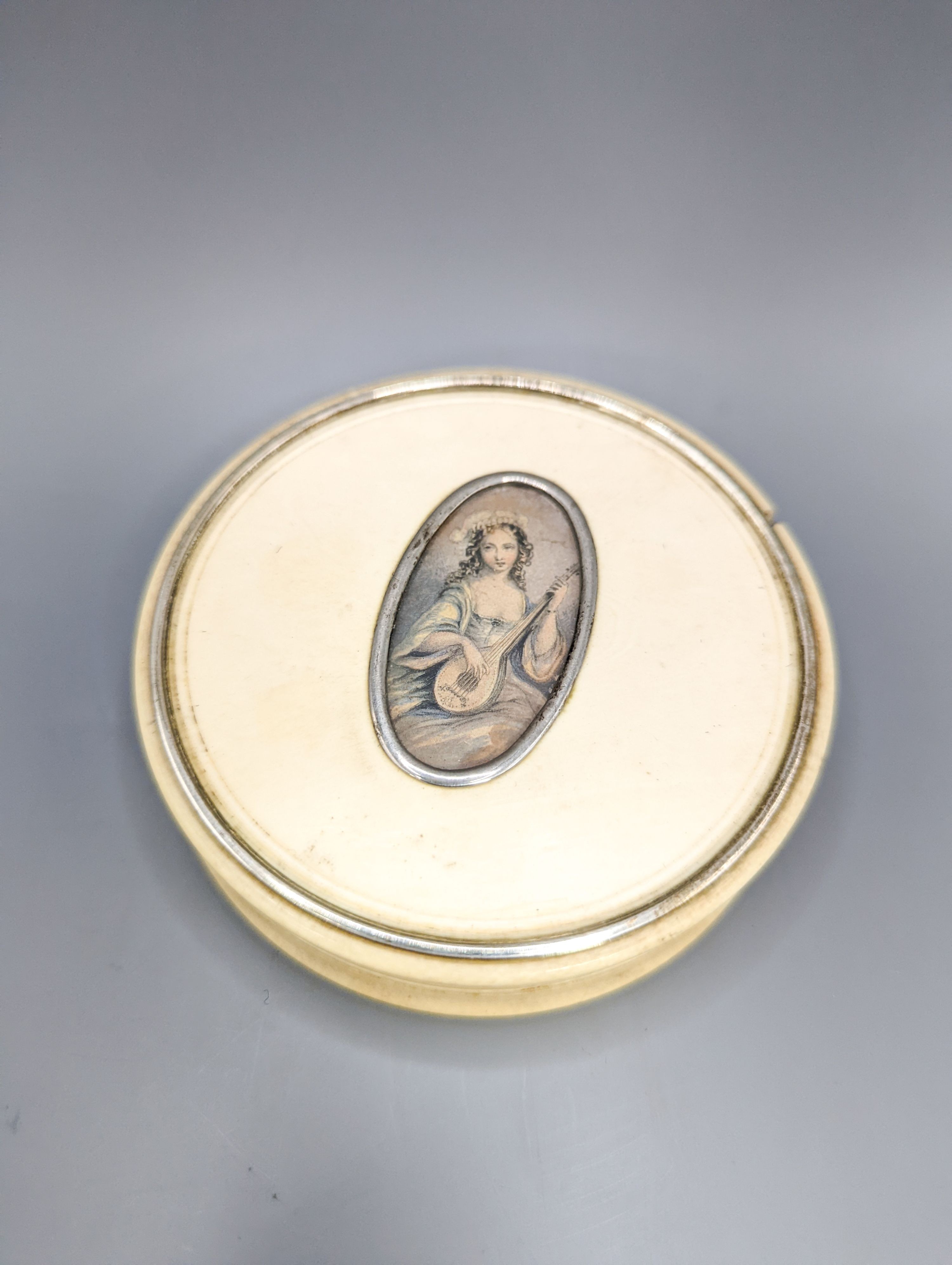 An early 19th century ivory circular box with central cartouche, a tortoiseshell match holder, diameter 9cm, and a pierced pot